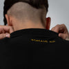 Back of black polo shirt with subtle Romans 8:31 embroidery meaning 'If God is for us, who can be against us