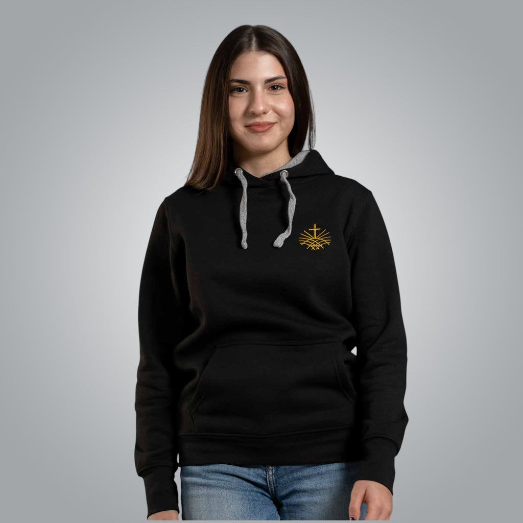 Woman wearing black Christian hoodie with gold embroidered Loom in Light emblem on the chest