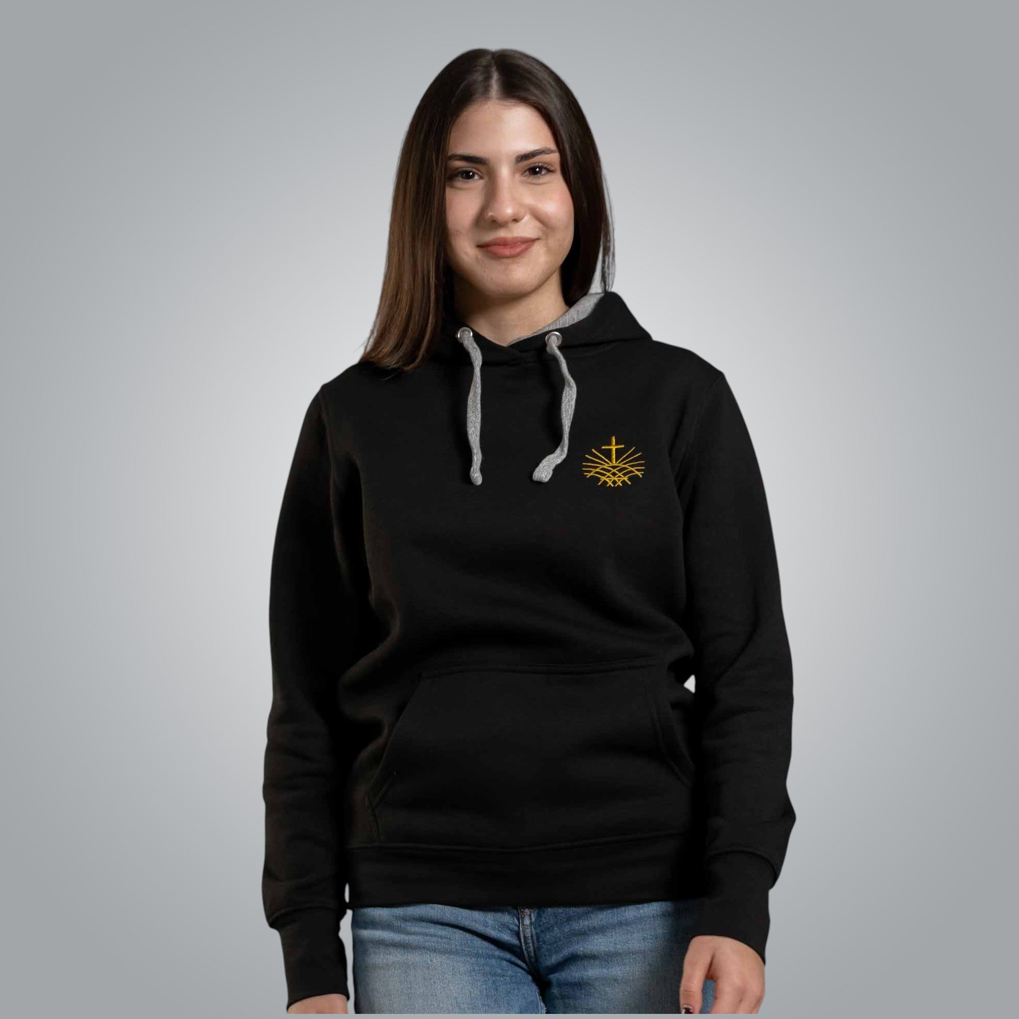 Woman wearing black Christian hoodie with gold embroidered Loom in Light emblem on the chest