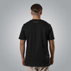 Back view of black men’s t shirt with gold embroidered Matthew 7:7 reference