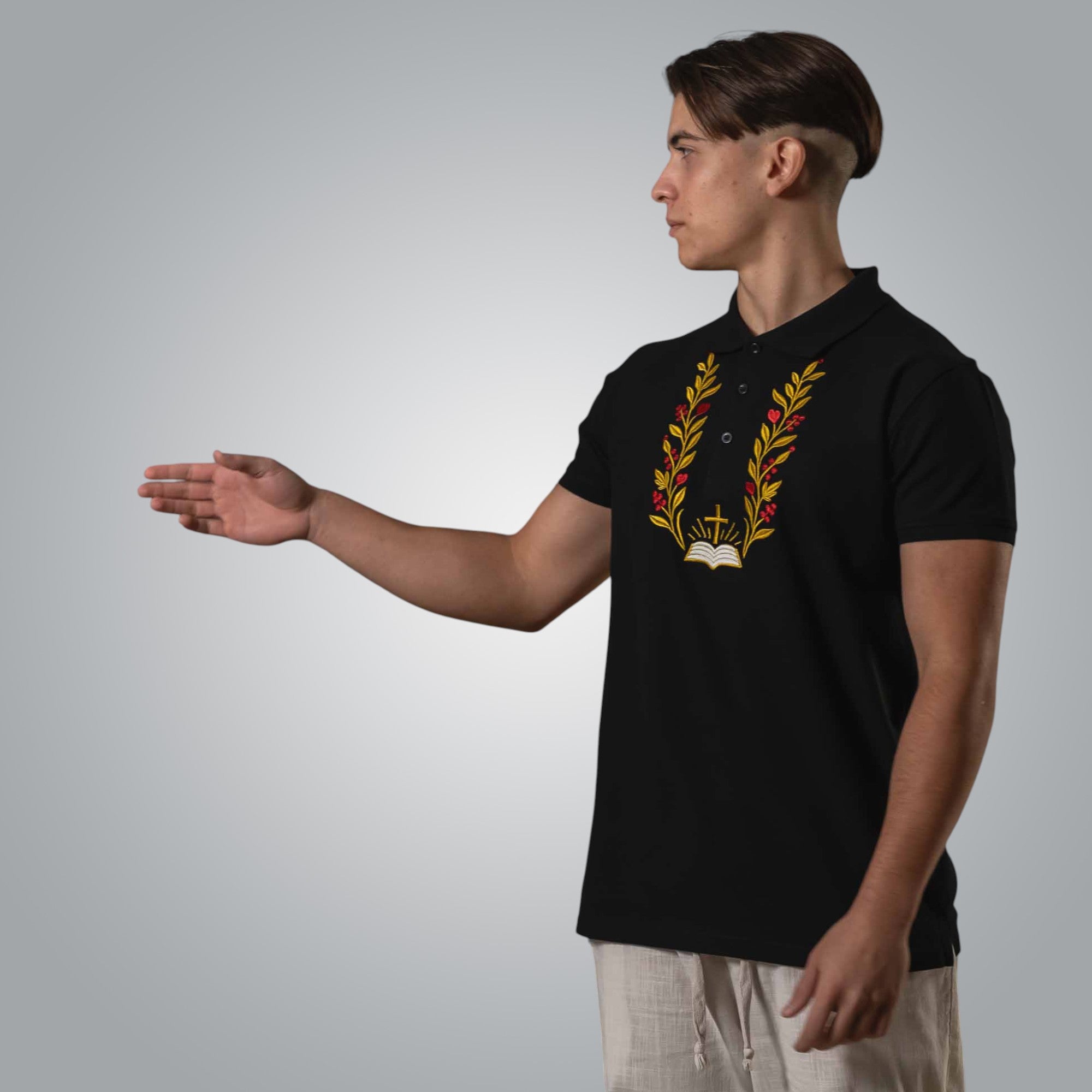 Side view of man in black Christian polo with embroidered branches and open Bible design