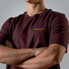 Close up of gold embroidered Romans 8:31 text on men’s burgundy Christian t shirt