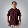 Man wearing burgundy Christian t shirt with gold embroidered Romans 8:31 text on the chest