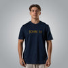 Man wearing navy Christian t shirt with gold embroidered John 1:1 text on the chest