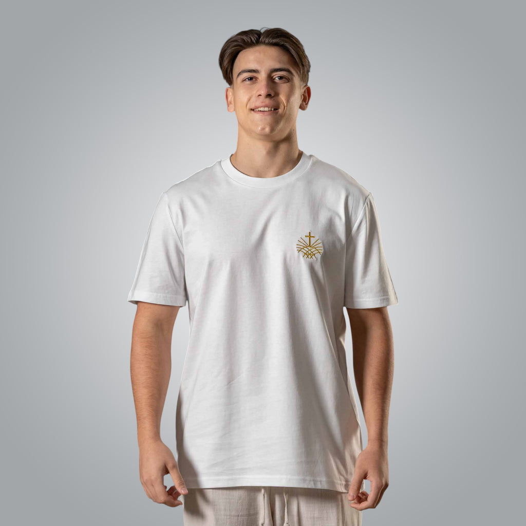 Man wearing white Christian t shirt with gold embroidered Loom in Light chest logo