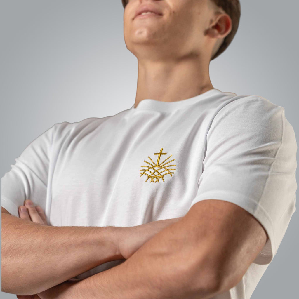 Close up of gold embroidered Loom in Light emblem on white men’s Christian t shirt