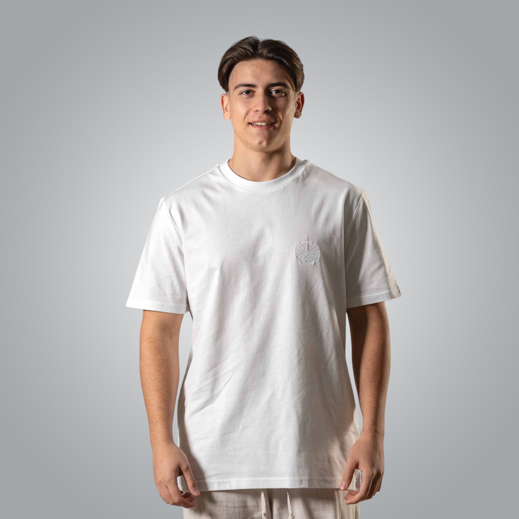 Man wearing white Christian t shirt with white embroidered Loom in Light logo on the chest
