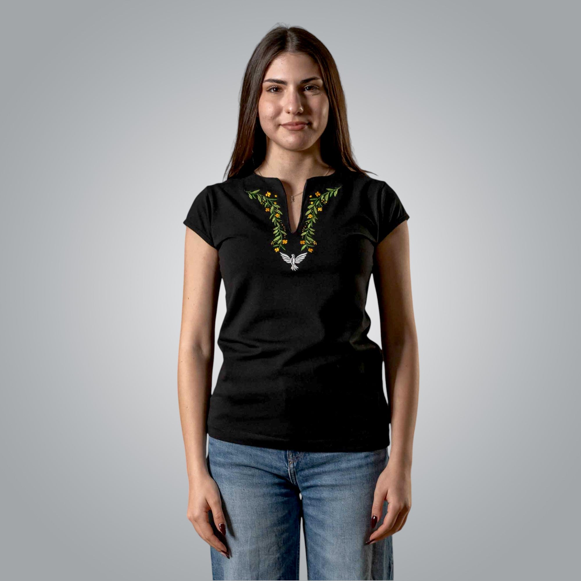 Woman wearing black V neck Christian t shirt with embroidered dove and floral design