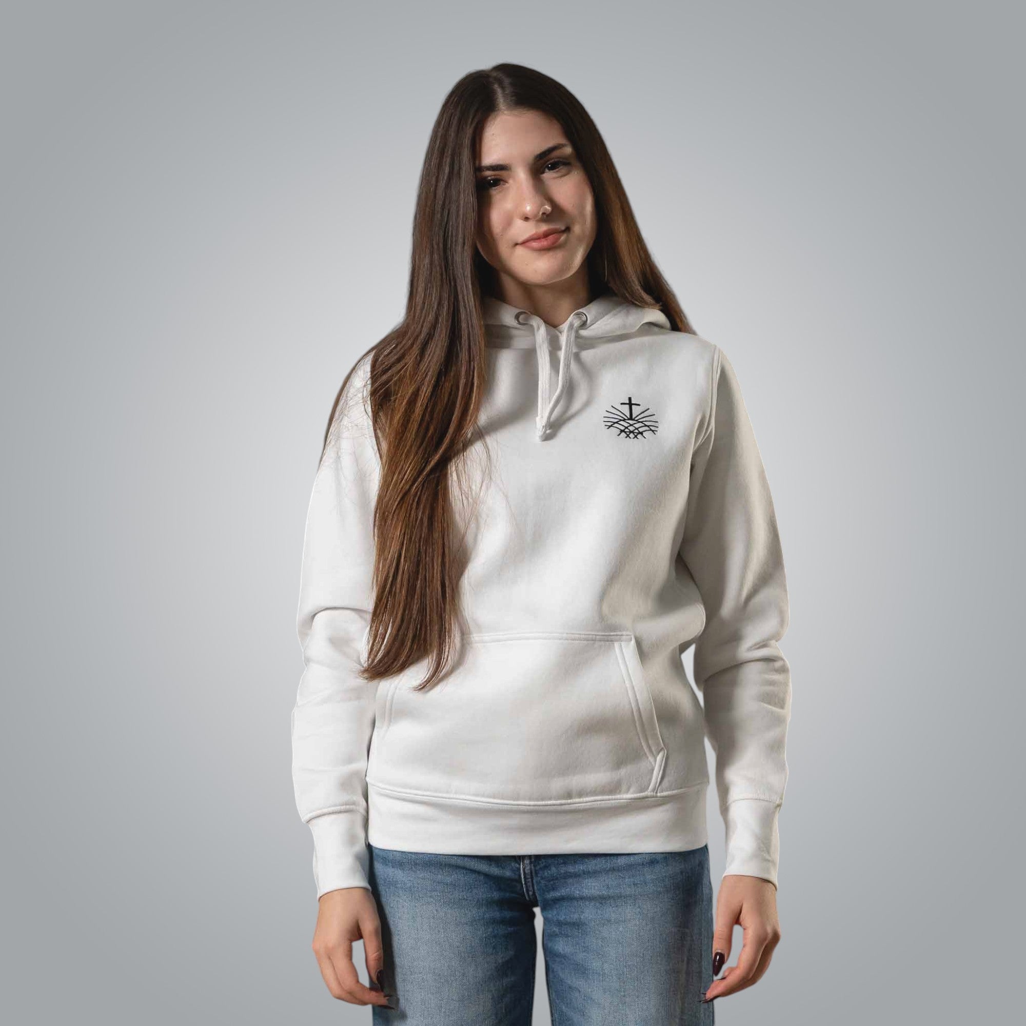 Woman wearing white Christian hoodie with black embroidered Loom in Light emblem on the chest