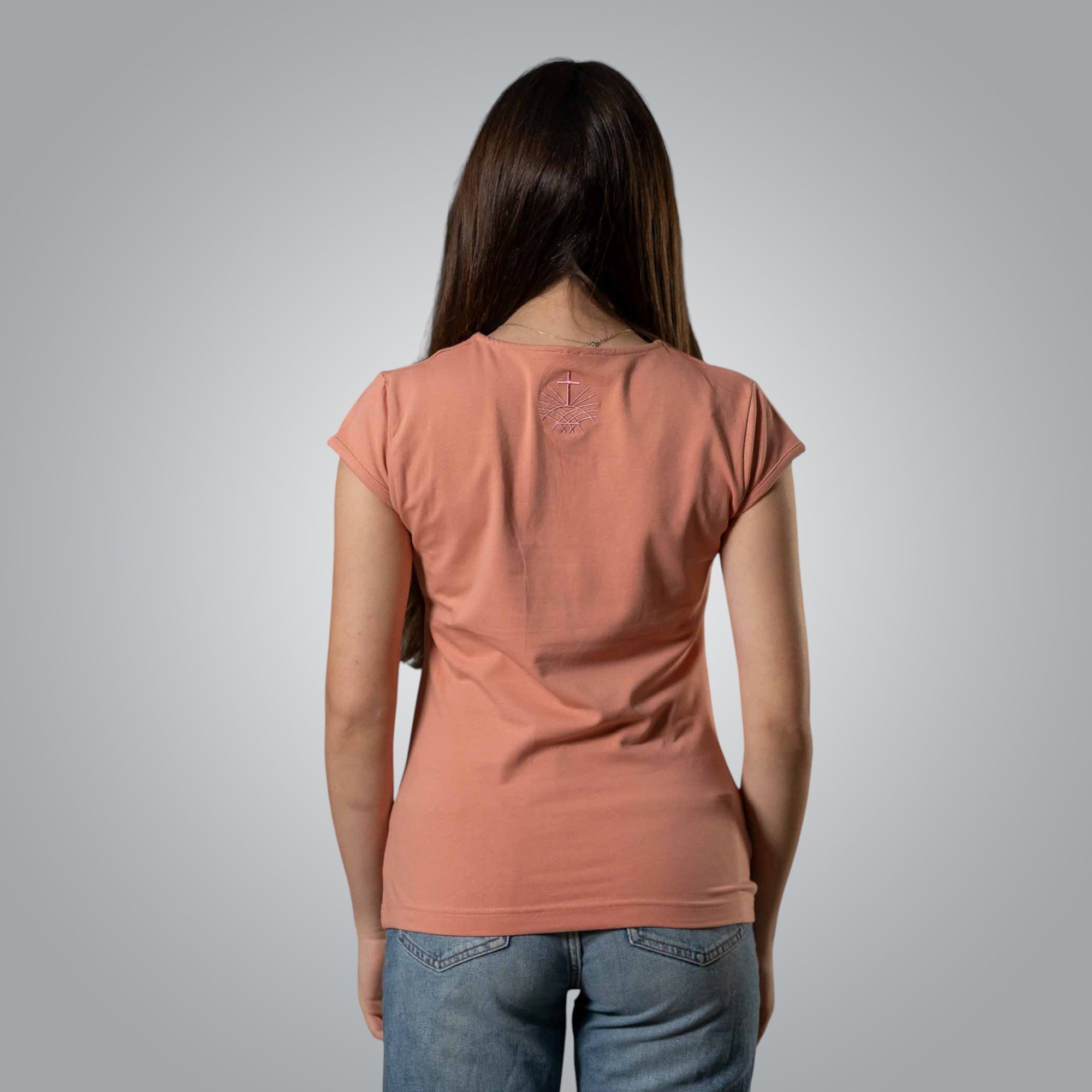Back view of peach women’s V neck Christian t shirt with embroidered Loom in Light emblem