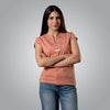 Woman wearing peach V neck Christian t shirt with embroidered open Bible cross and branches