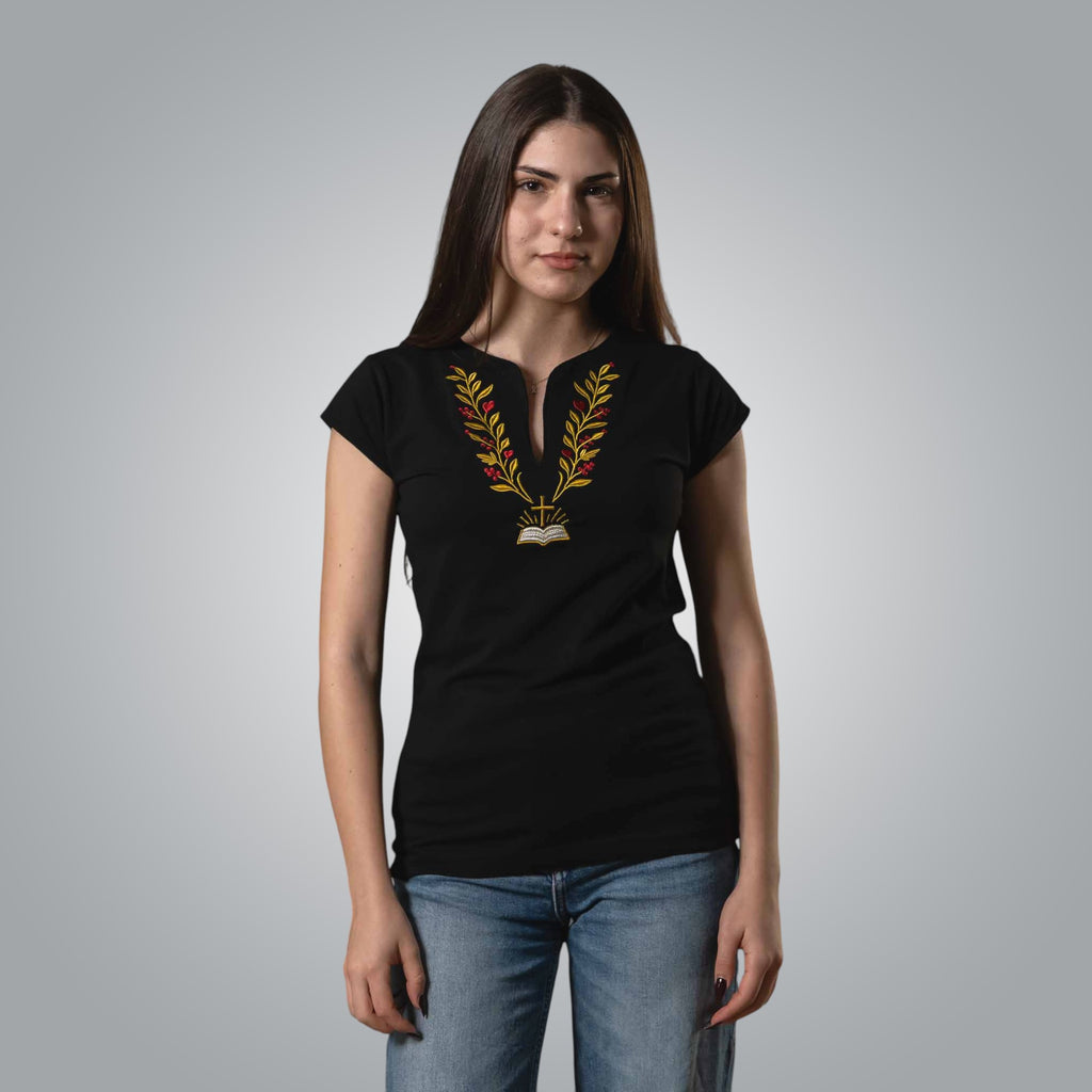 Woman wearing black V neck Christian t shirt with embroidered Bible cross and branch design