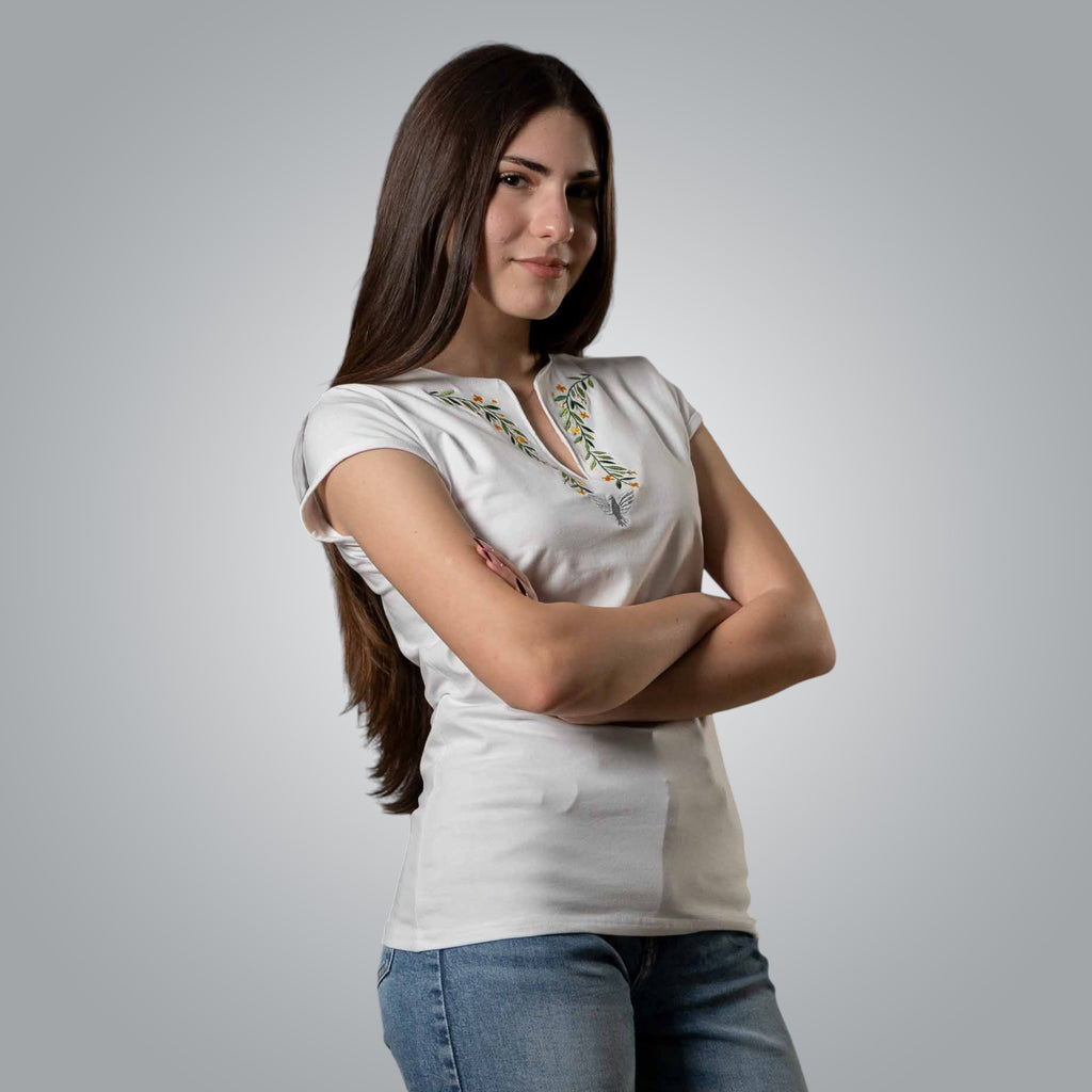 Front view of woman in white Christian V neck t shirt with dove and floral embroidery